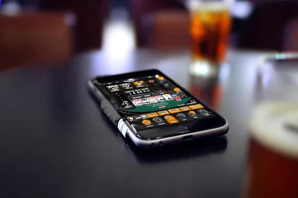 4777BED Mobile App — Your complete hub for casino and sports A man focused on his laptop with live stats in the background, highlighting the dedicated sports and gaming features of the 4777BED mobile app.