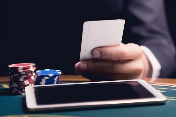 A confident dealer surrounded by casino chips inviting players to access their 4777BED account, reflecting quick and easy login options.
